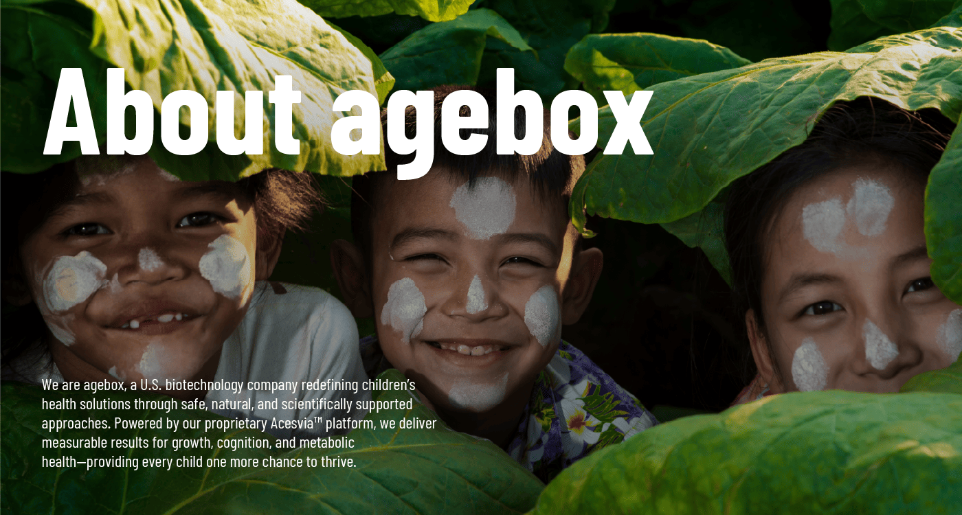 The 'About agebox' page banner, featuring three happy children smiling from behind large green leaves. It represents agebox's mission as a U.S. biotechnology company to provide safe, natural, and scientifically supported health solutions for every child to thrive.